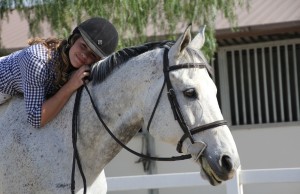 Megan Vliestra, sophomore, poses for a photo with her horse, Rhett, during practice. Megan Vliestra/With Permission