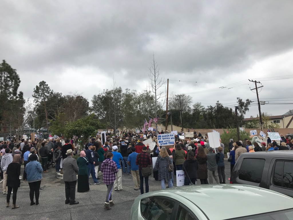 American flags waved over the heads of the protesters that filled the parking lot of the Islamic Center of Conejo Valley on Feb. 5. Signs of protest dotted the crowd, including one that read "NO MUSLIM BAN NO BORDER WALL OUR CITIES STAND TALL."